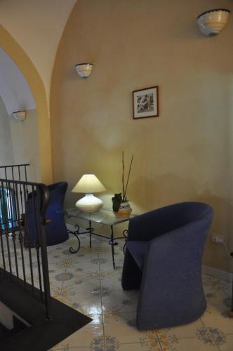 a living room with a couch and a table at Hotel Savoia in Procida