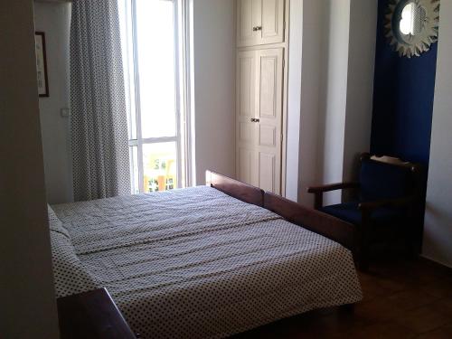 a bedroom with a bed and a window at Eleni Studios in Agios Nikolaos