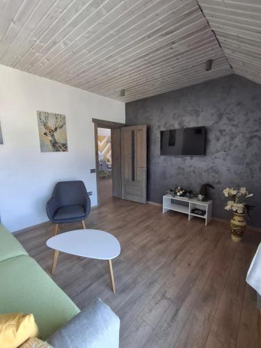 a living room with a couch and a table at Котедж у горах "Місце Сили" in Vorokhta