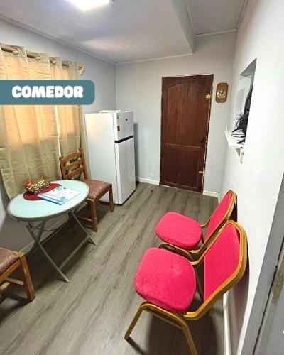 a room with a table and chairs and a refrigerator at Apartamento para tres personas a cuadras del hospital in Paysandú