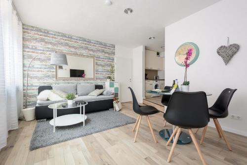 a living room with a couch and a table at Deluxe Appartements am Münster in Freiburg im Breisgau