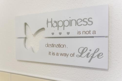 a sign that says happiness is not a destination its a way of life at Deluxe Appartements am Münster in Freiburg im Breisgau