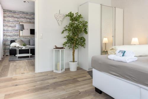 a bedroom with a bed and a living room at Deluxe Appartements am Münster in Freiburg im Breisgau