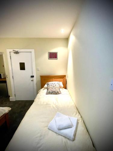 a bed with two towels on it in a room at Stag and Barrel in Elgin
