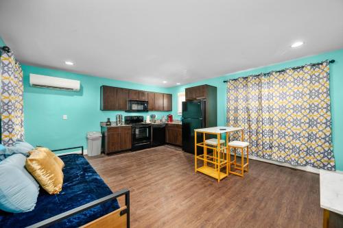 a living room with a couch and a kitchen at Sleek 1BR Retreat Near NRG and Med Center in Houston