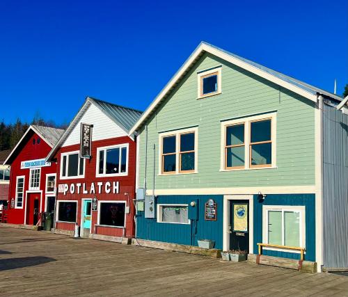 a group of buildings on a pier with a boardwalk at Inn At Creek Street in Ketchikan