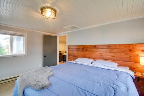 a bedroom with a blue bed with a wooden headboard at Ocean-Themed Westport Home Bike to Ocean! in Westport