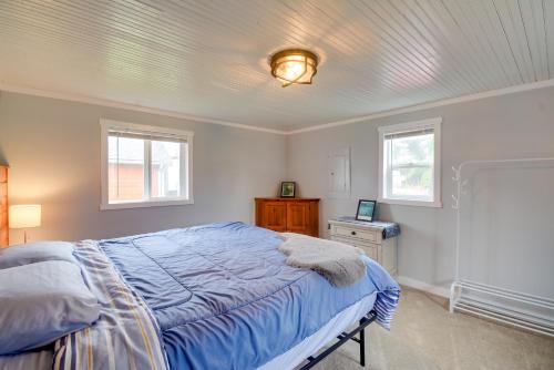 a bedroom with a bed and two windows at Ocean-Themed Westport Home Bike to Ocean! in Westport