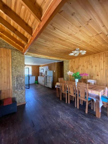 a dining room with a table and wooden walls at CASA A11 Lago Rapel in El Estero