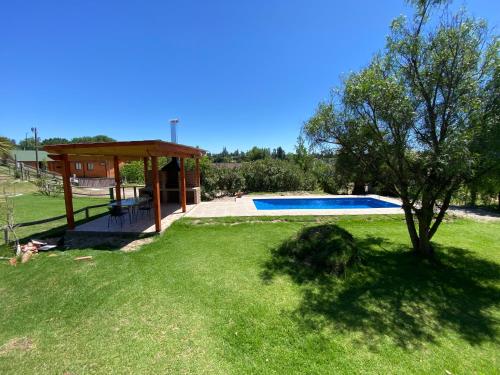 a yard with a pavilion and a swimming pool at CASA A11 Lago Rapel in El Estero