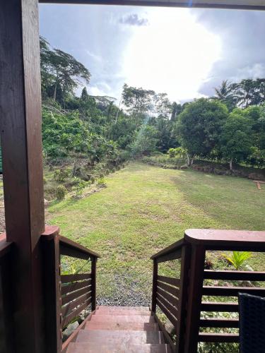 a view of a field from the porch of a house at Hava'i Lodge in Taputapuapea