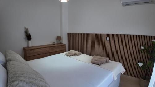 a bedroom with two beds with towels on them at Apartment Las 2 in Fanárion