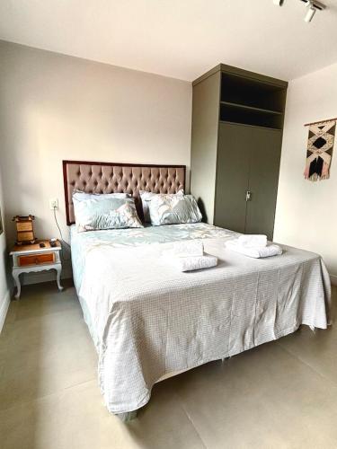 a bedroom with a large bed with two pillows on it at Flat Mirant Vila Madalena in São Paulo