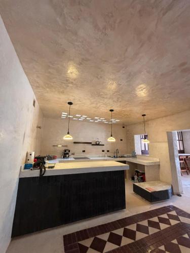a large kitchen with a large island in a room at Casona La Jacinta in Sisal