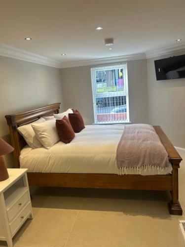 a bedroom with a large bed with a window at Derry City Apartment in Derry Londonderry