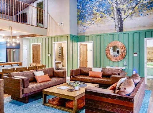 a living room with two couches and a table at Copper Cottage French Lick in French Lick