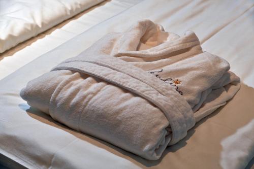 a hoodie is sitting on top of a bed at Villa Paulina in Brela