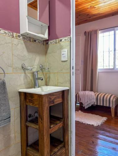 a bathroom with a sink in a room at Dormís La Cabaña in San Antonio de Areco