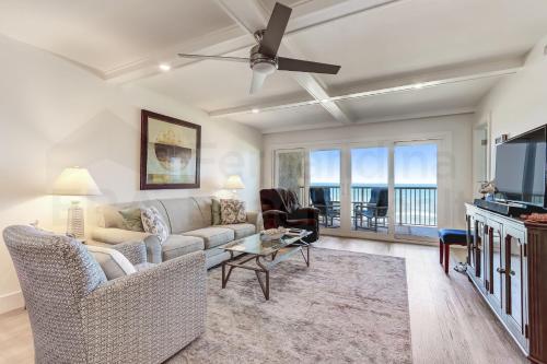 a living room with a couch and a tv at High End Coastal Feel Condo in Fernandina Beach