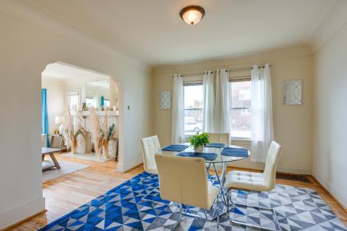 a dining room with a glass table and white chairs at Pet-Friendly Detroit Apt Near Motown and DIA in Detroit