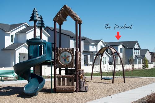 a playground with a slide and two swings at Play Relax Ping Pong, Foosball, Arcades, Park in Meridian