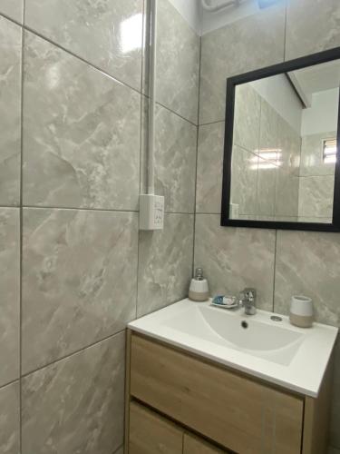 a bathroom with a sink and a mirror at Casita el Emir in Plottier