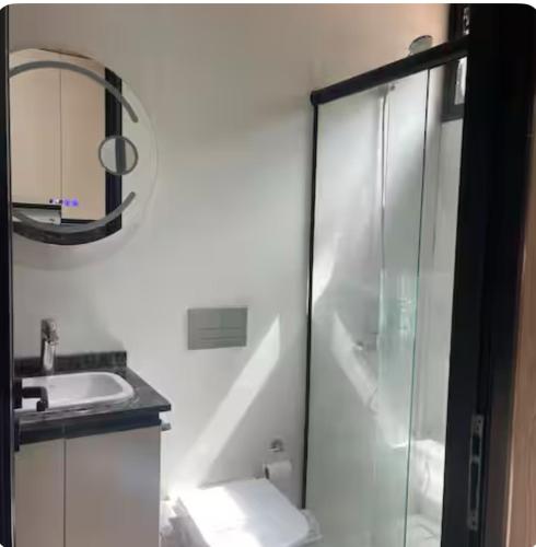 a bathroom with a glass shower and a sink at Cabaña sobre Playa Lago Gutierrez 1 in San Carlos de Bariloche