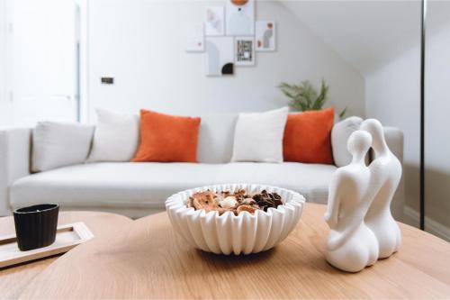 a living room with a bowl of food on a table at Luxury 2 BD with Free Parking & WIFI, Near Train Station and Stockport Hospital in Stockport