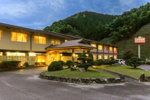 a hotel building with a sign in front of it at Ichinomata Onsen Grand Hotel in Shimonoseki