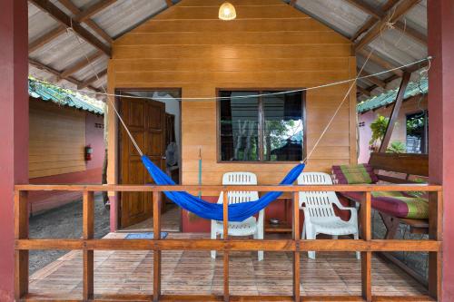 a hammock on the front porch of a house at Family Song Koh Lipe in Ko Lipe