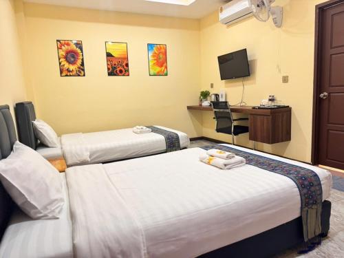 Katil atau katil-katil dalam bilik di Yula Hotel