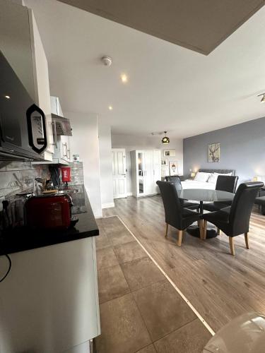 a kitchen and living room with a table and chairs at Abbey Apartments in Dublin
