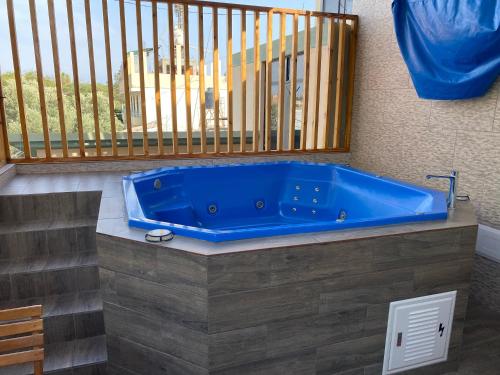 a blue tub in a room with a balcony at Del Valle House in Ica
