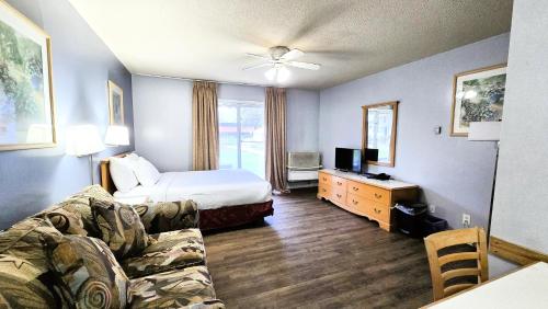 a living room with a bed and a couch at Okanagan Seasons Resort in Kelowna