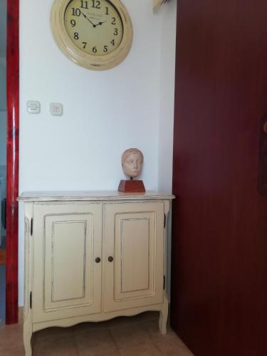 a clock on the wall above a white cabinet at Apartments by the sea Prvic Luka, Prvic - 21276 in Prvić Luka