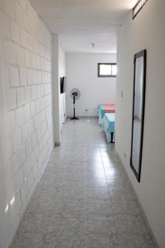 a hallway of a room with two beds and a mirror at Apartamento con buena ubicación PARA FAMILIA Grande in Cali