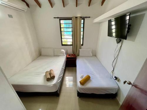two beds in a small room with a tv at 202 swiss hostel Bern in Gaira