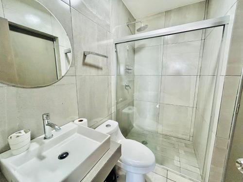 a bathroom with a toilet and a sink and a shower at penthouse vista a 5min de la playa by G P S rentas in Mazatlán