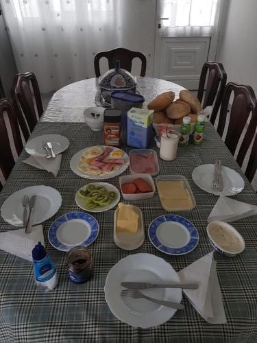 een tafel met daarop borden met eten bij Pérola Achadense Guesthouse in Achada