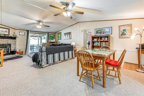 a living room with a bed and a table at Fire Pit and Decks Creekside Cabin in Robbinsville in Robbinsville