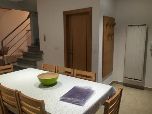 a dining room with a table with a bowl on it at Gites Des Sablons in Châtillon-sur-Marne