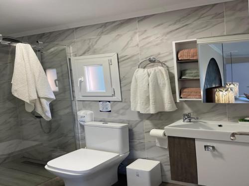 a bathroom with a toilet and a sink at Villa in Alykes with Private Pool & Sea Views in Alykes