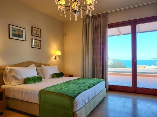 a bedroom with a bed and a large window at Villa in Hersonissos by Sandy Beach & Pool in Hersonissos