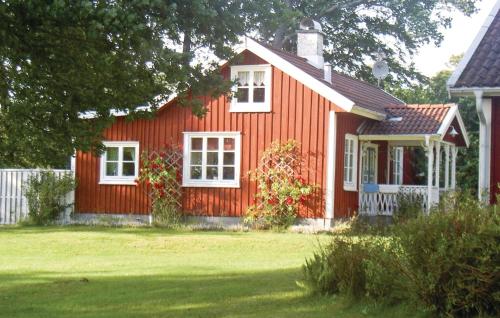 a red house with white windows and a yard at Holiday Home Sjöhagen Ljungby in Bolmstad
