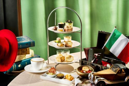 a table topped with three tiered plates of pastries at The Ritz-Carlton Osaka in Osaka
