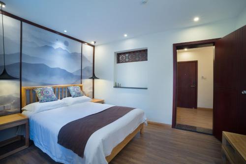 a bedroom with a large bed in a room at Riverside Inn Guilin Central in Guilin