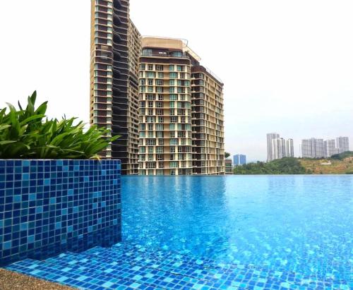 a swimming pool in front of a tall building at D'Pristine Medini Johor Bahru in Nusajaya