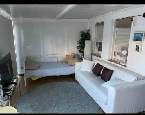 a living room with a white couch and a tv at Beautiful apartment Pontevedra in Sanxenxo