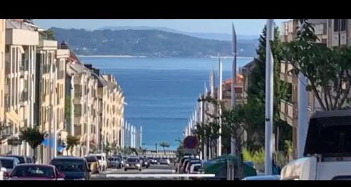 a city street with cars parked on the street at Beautiful apartment Pontevedra in Sanxenxo