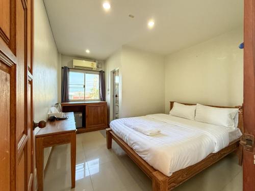 a small bedroom with a bed and a window at Sea Inn Hua Hin 55 in Hua Hin